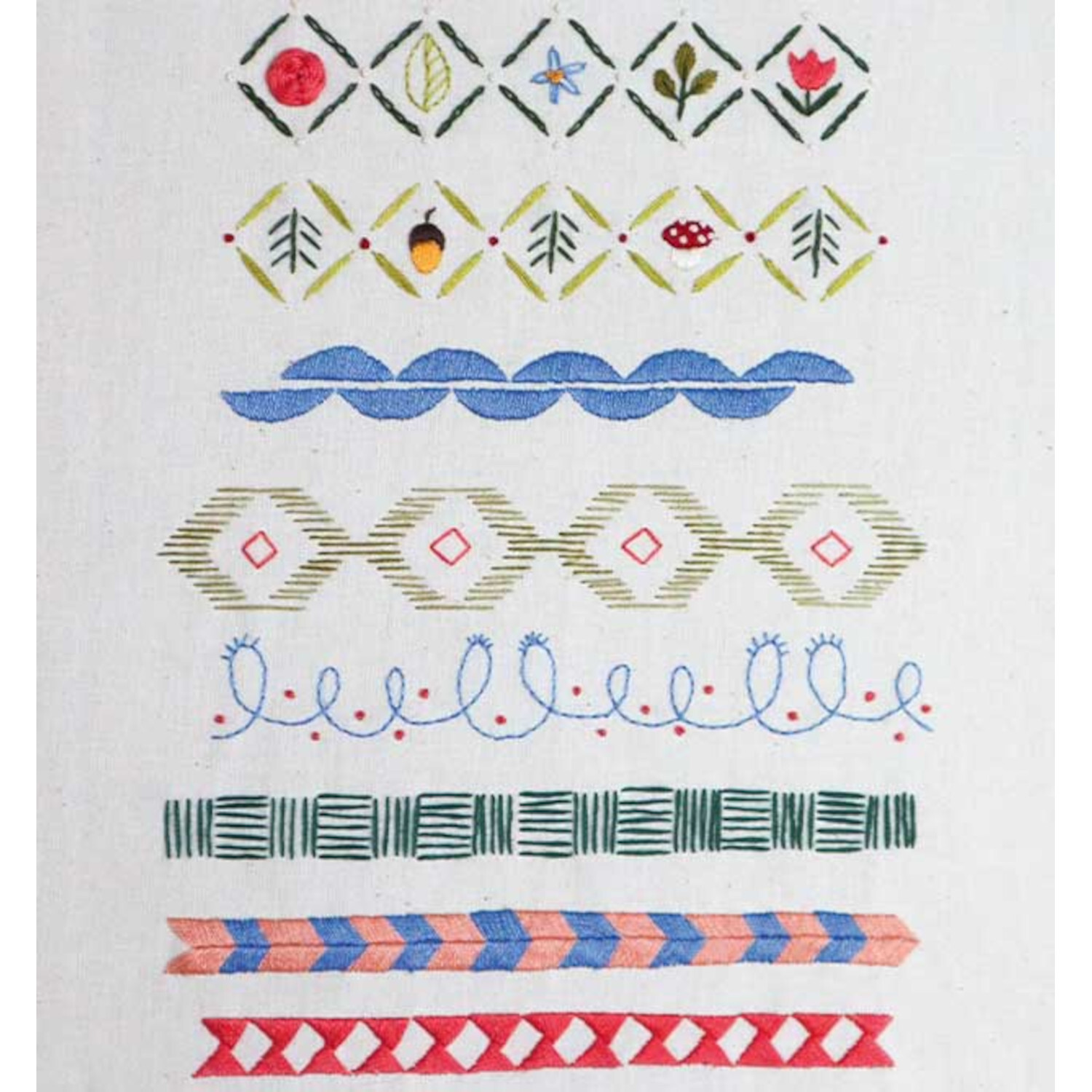 Sticken. Die Motivsammlung: Verschiedene Stickmuster in bunten Farben auf weißem Stoff.