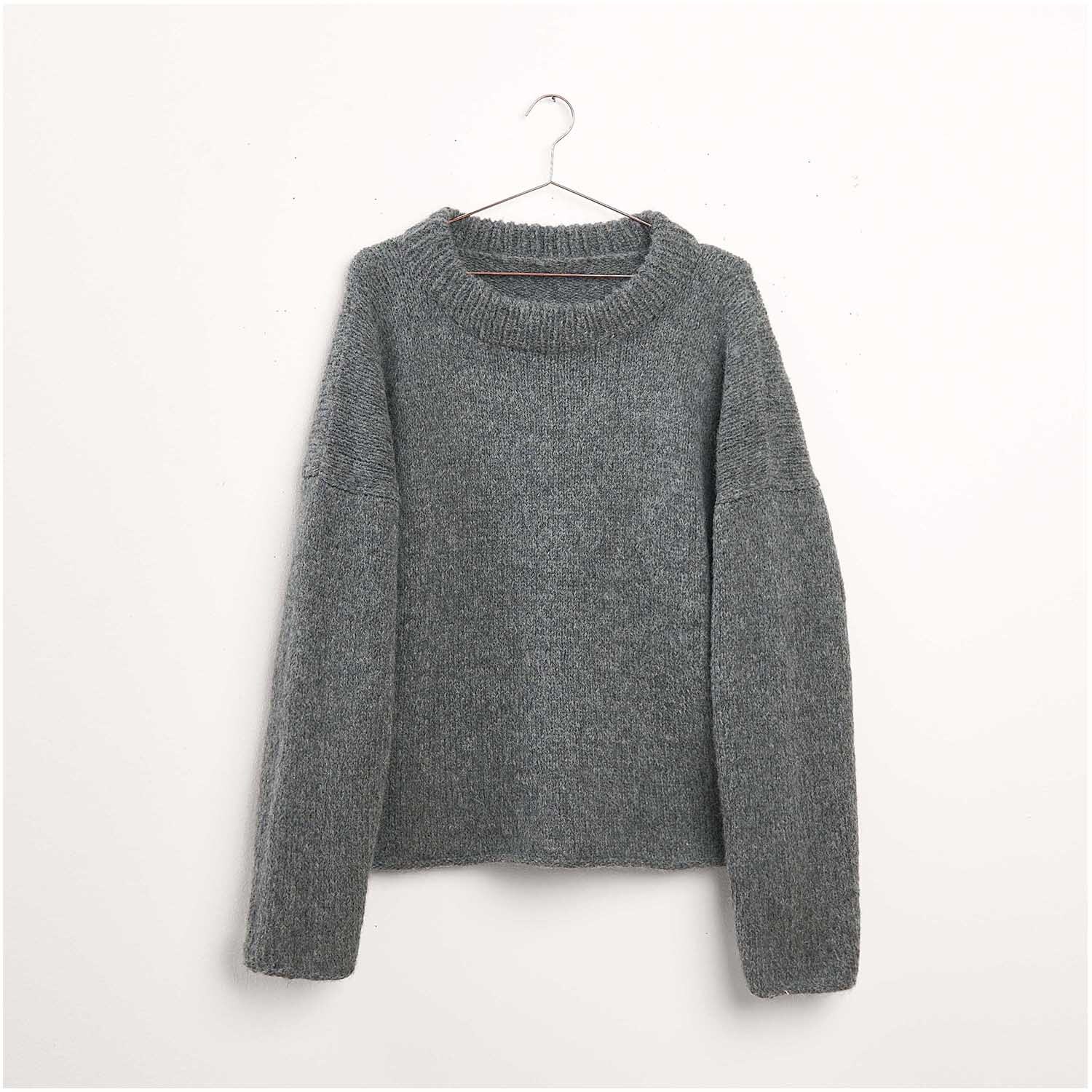 Strickset Pullover Modell 17 aus Luxury Knits Winter Special von Rico Design Strickset Pullover Modell 17 aus Luxury Knits Winter Special: Grauer Pullover auf einem Kleiderbügel vor weißem Hintergrund.