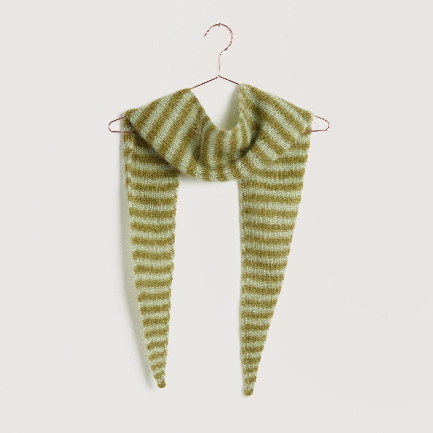 Strickset Tuch Modell 21 aus Lovewool No. 22: Gestreiftes Tuch in Aloe-Weide auf einem Kleiderbügel.