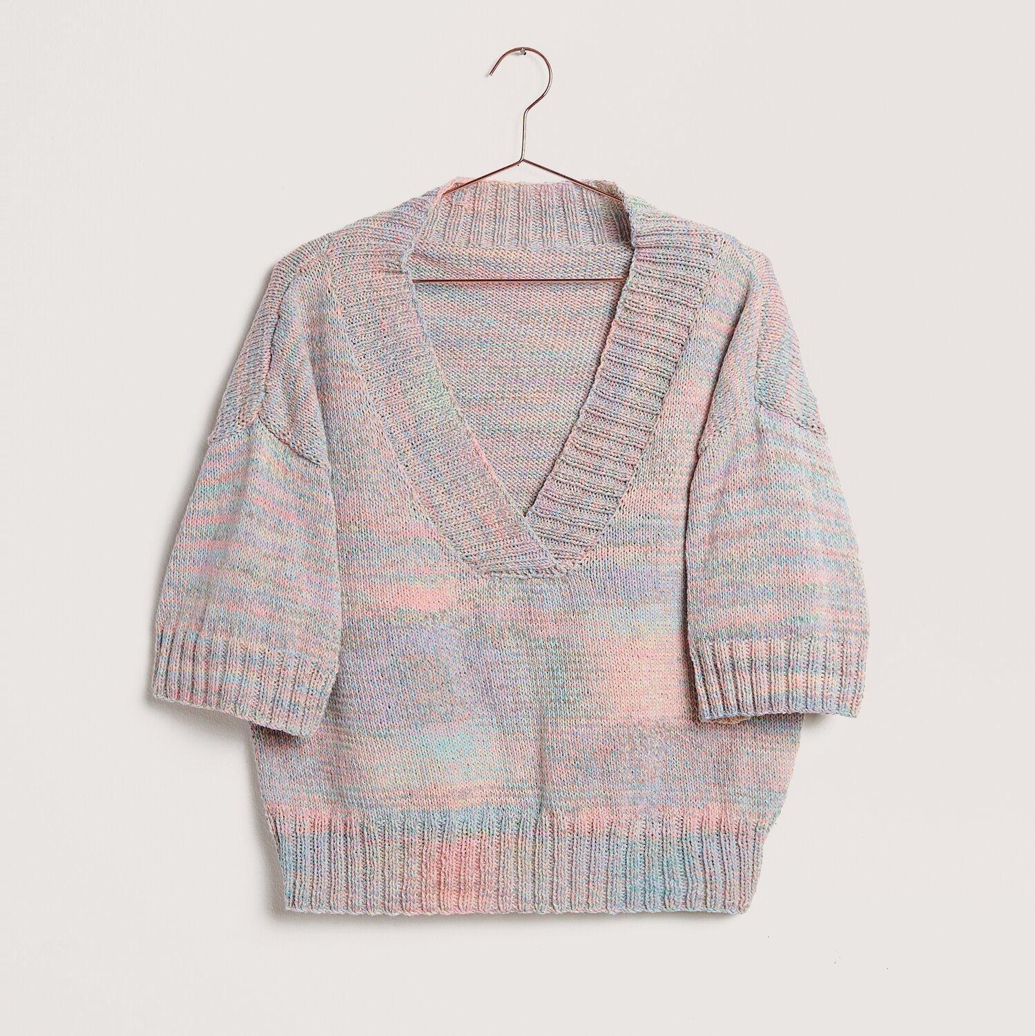 Die Neue Masche No. 12 Frühjahr-Sommer von idee. Creativmarkt Die Neue Masche No. 12 Frühjahr-Sommer Pullover mit V-Ausschnitt in Pastelltönen auf Bügel.